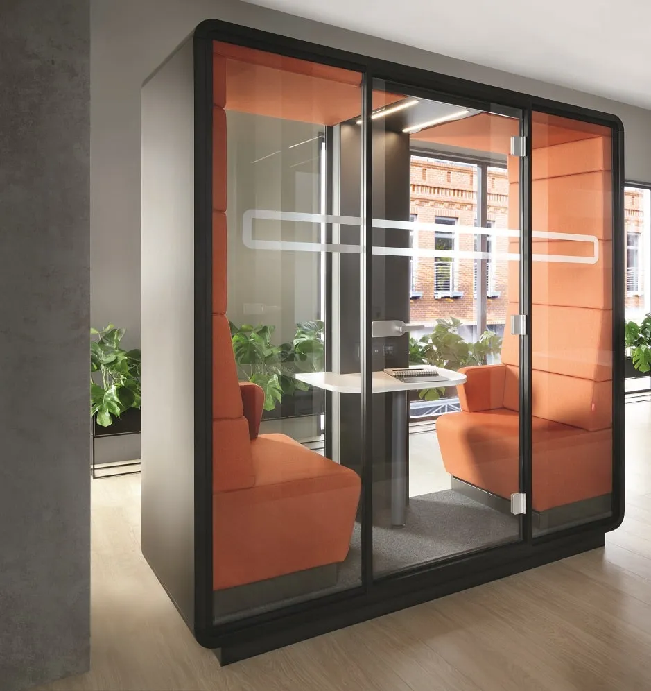 Bright, modern office room with shared seating and natural daylight